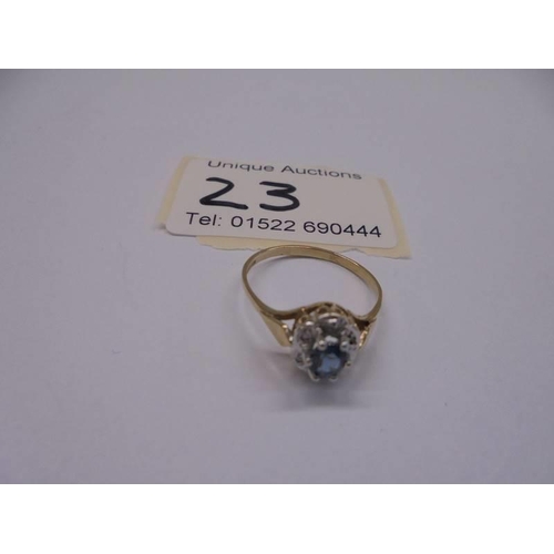 23 - A diamond and blue stone set ring in 9ct gold, size O half, 1.55 grams.