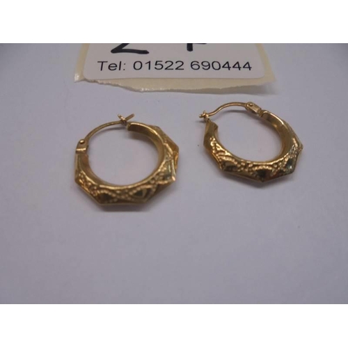 27 - A pair of 9ct gold textured hoop earrings.