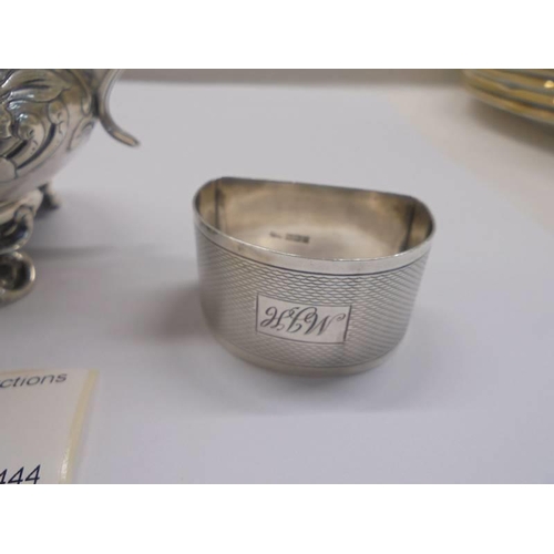 29 - A silver milk jug and a silver napkin ring.