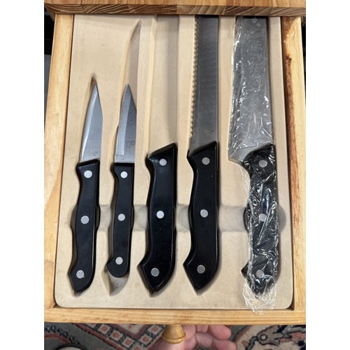 1855 - A chopping board with integral drawers with knives & other cutlery etc.