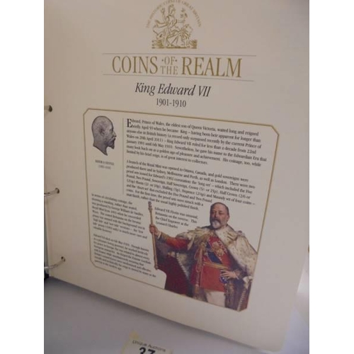 37 - A coins of the realm folder with a Queen Elizabeth II cover, a D Day cover and a replica newspaper.