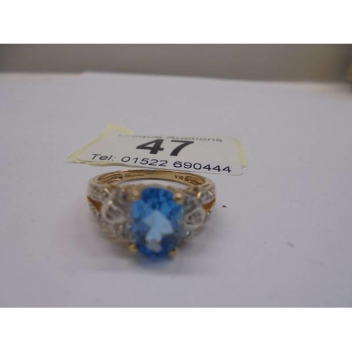 47 - A 9ct gold vintage topaz and diamond ring, size O, 2.98 grams.