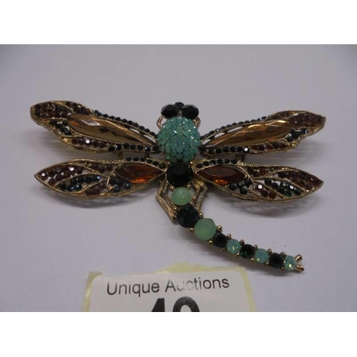 49 - A large stone set dragonfly brooch/pendant in yellow metal.