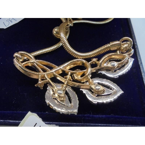 50 - A superb quality floral spray stone set pendant in yellow metal.