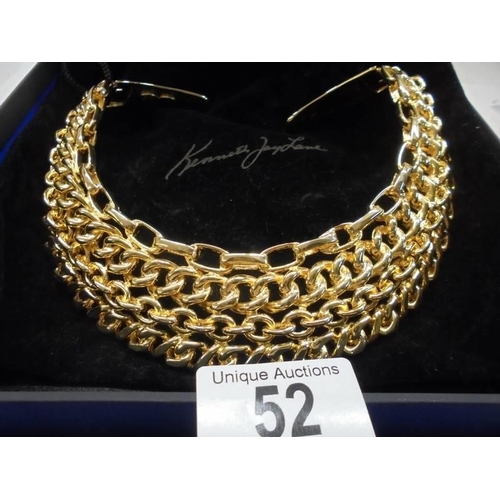 52 - A cased yellow metal collar/choker by Kenneth Lane, USA.