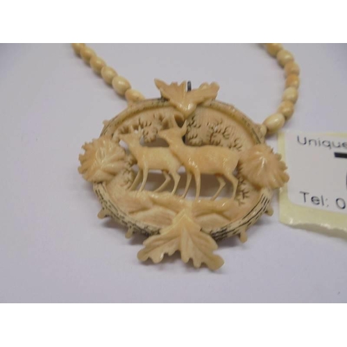 70 - A carved pendant featuring deer.