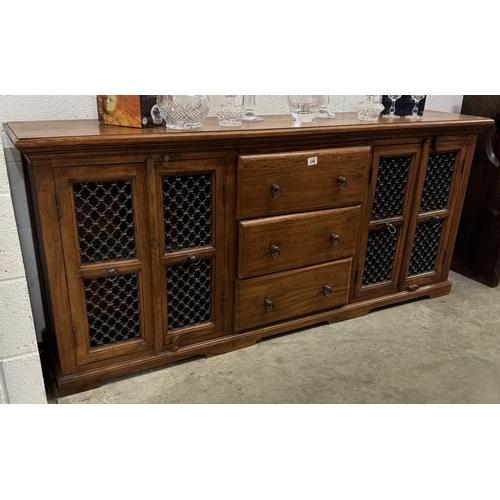 346 - A John Lewis Maharani teak sideboard with iron door panels