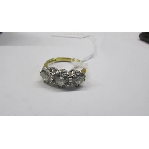 50 - An 18ct three stone diamond ring, size Q. 5.41 grams.