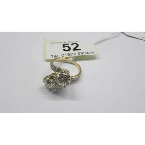 52 - An 18ct gold ring set two x two carat diamonds, size O, total weight 7.4 grams.