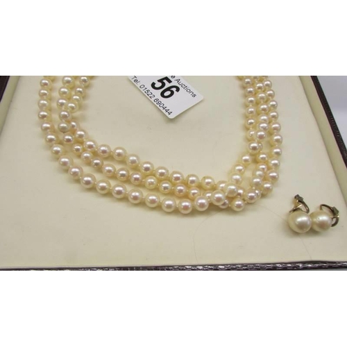 56 - A triple strand pearl necklace with 18ct and diamond clasp with original receipt.