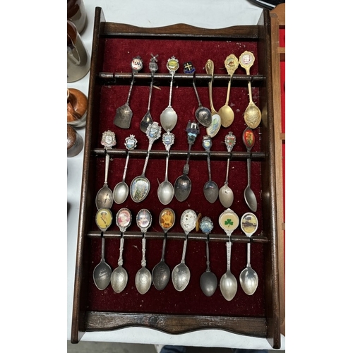 1910R - A large collection of ceramic thimbles & tourist spoons on display racks