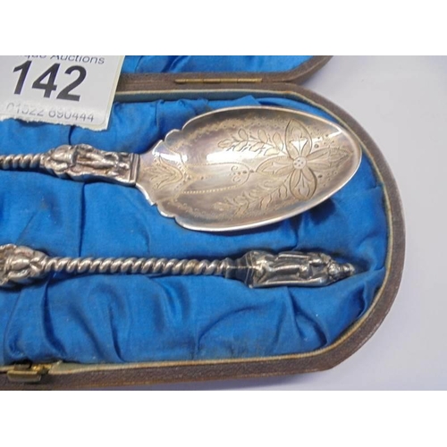 142 - A cased pair of white metal apostle spoons (test as silver).