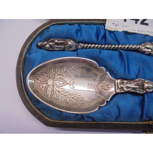 142 - A cased pair of white metal apostle spoons (test as silver).