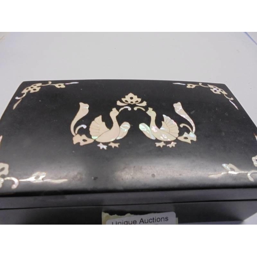 146 - A black lacquered and mother of pearl inlaid casket.