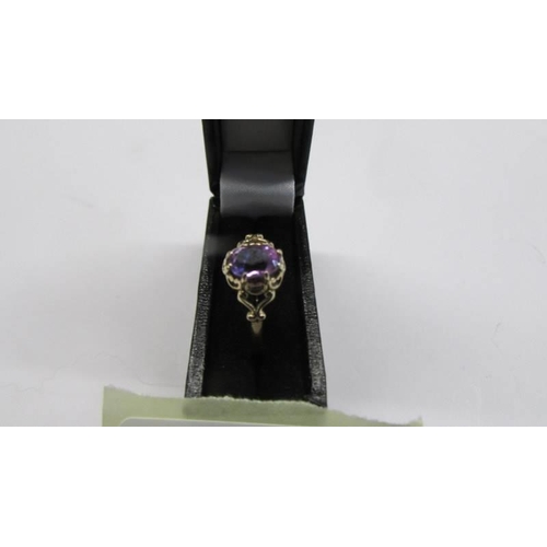 77 - A 9ct gold amethyst ring with fancy shoulders, size P, 1.4 grams.