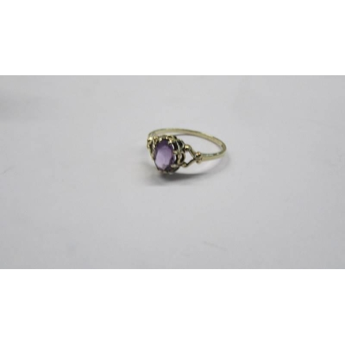 77 - A 9ct gold amethyst ring with fancy shoulders, size P, 1.4 grams.