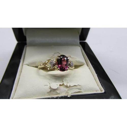 78 - A 9ct gold ring set red stone with diamond shoulders, size R, 2.3 grams.