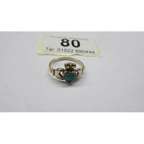 80 - A 9ct gold Irish Claddagh ring set with a green stone, size M, 1.5 grams.