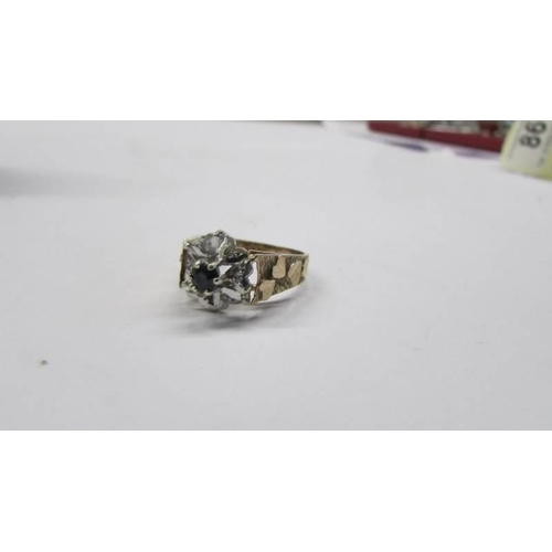 85 - A diamond sapphire ring in a cluster design, hall marked Birmingham 1976 in 9ct gold shank, size N h... 