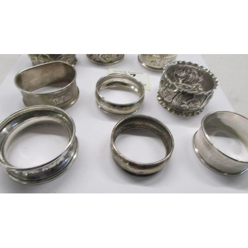 97 - Twelve assorted silver napkin rings.