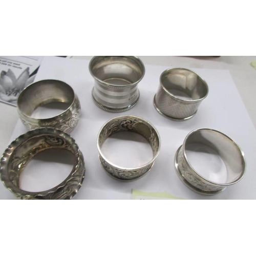 97 - Twelve assorted silver napkin rings.