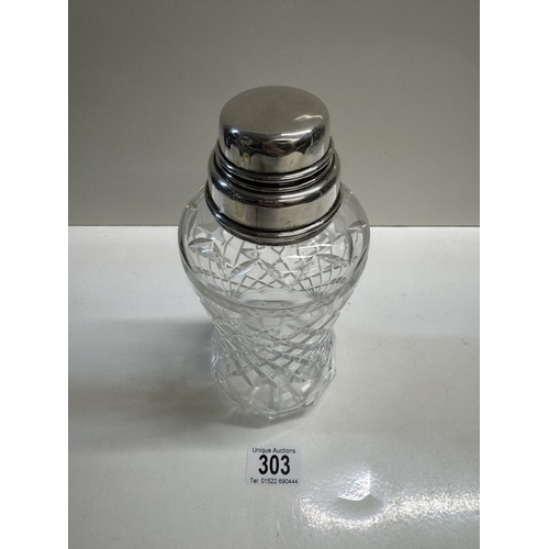 303 - A cut glass cocktail shaker with sterling silver fittings. Height 22.5cm