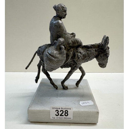 328 - A Spelter figure of a woman on a donkey