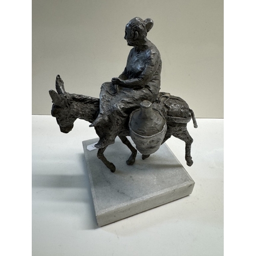 328 - A Spelter figure of a woman on a donkey