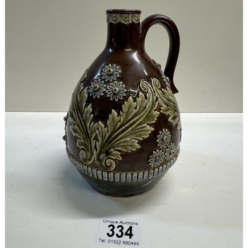 334 - A 19th century Lambeth whiskey bottle with raised floral decoration