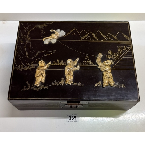 339 - An oriental lacquered jewellery box. 33.5cm x 25.5cm x 11cm