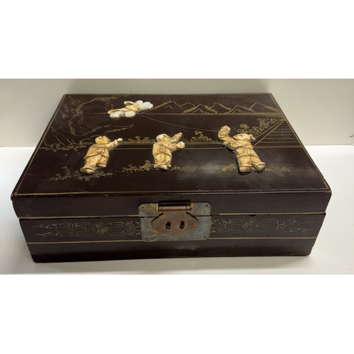 339 - An oriental lacquered jewellery box. 33.5cm x 25.5cm x 11cm