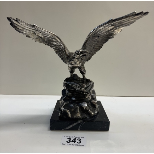 343 - A large plated metal eagle on black stone plinth