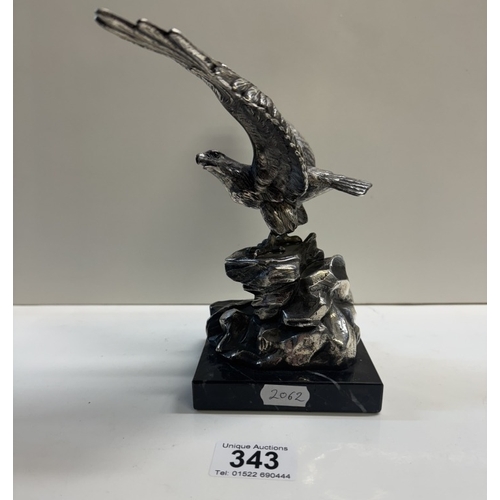 343 - A large plated metal eagle on black stone plinth