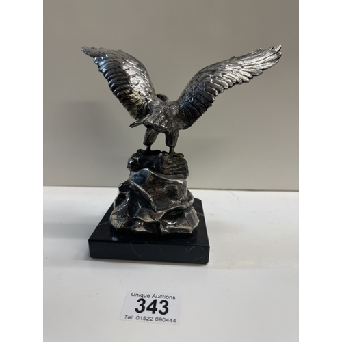 343 - A large plated metal eagle on black stone plinth