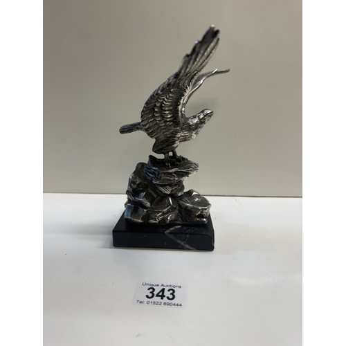 343 - A large plated metal eagle on black stone plinth