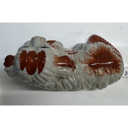 347 - A pair of Staffordshire style ceramic dogs in the lying down position