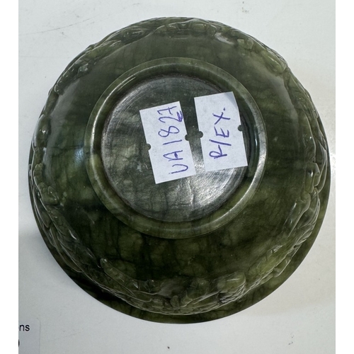 352 - A small antique spinach jade bowl carved around the exterior with archaistic dragons. 13cm diameter