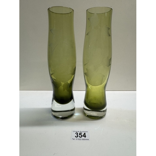 354 - A pair of green art glass vases with deep cut leaves & bird decoration