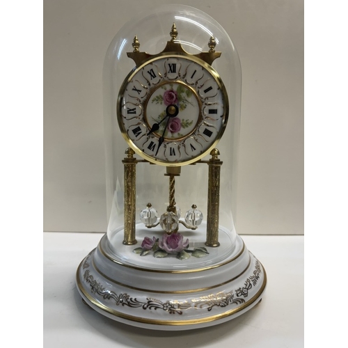 362 - A Quartz anniversary clock on floral ceramic stand with glass dome