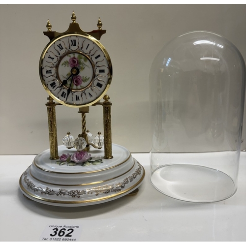 362 - A Quartz anniversary clock on floral ceramic stand with glass dome