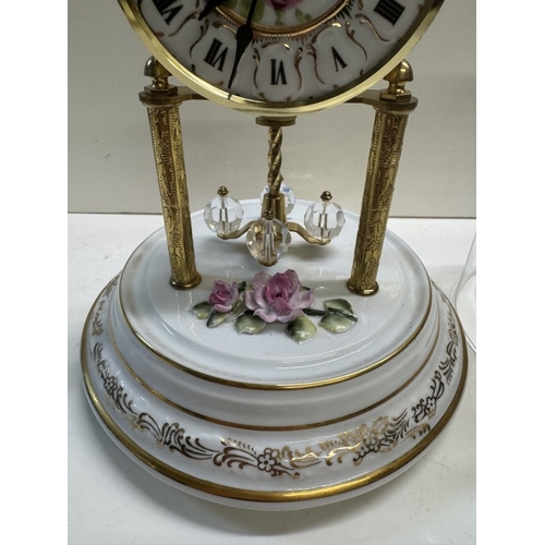 362 - A Quartz anniversary clock on floral ceramic stand with glass dome