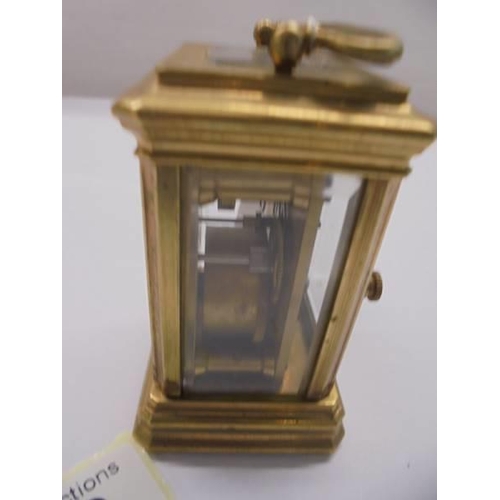 168 - A miniature brass carriage clock.