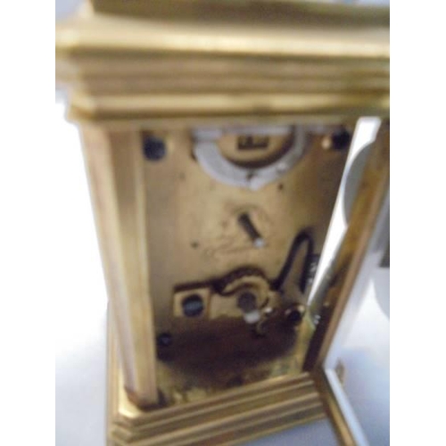 168 - A miniature brass carriage clock.