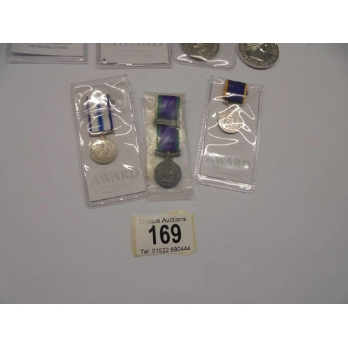 169 - Four Queen Elizabeth II award medals and three miniature examples.