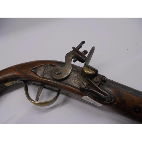 173 - An early 19th century Flintlock pistol with brass and iron fittings.