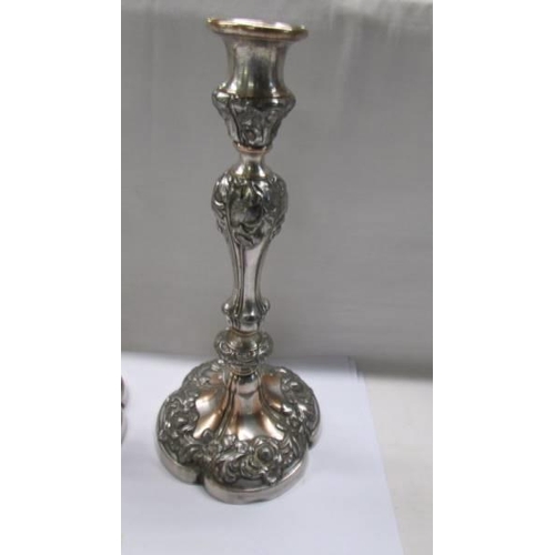 189 - A pair of ornate Sheffield plate candlesticks  (some plate loss)