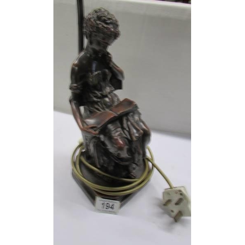 194 - A table lamp featuring a female figure reading.