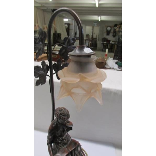 194 - A table lamp featuring a female figure reading.