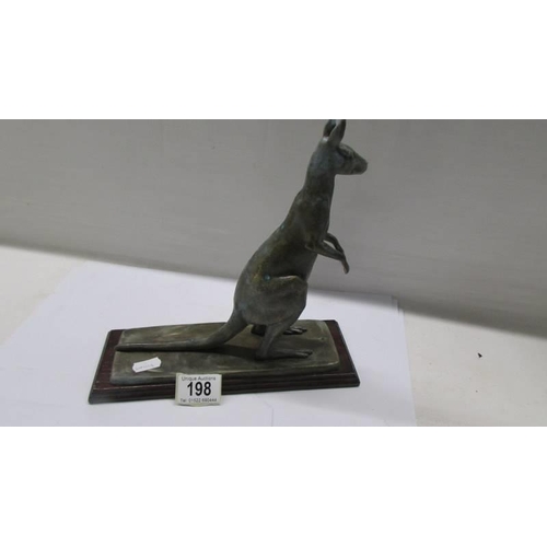 198 - A metal kangaroo on a wooden base.