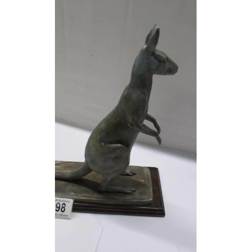 198 - A metal kangaroo on a wooden base.